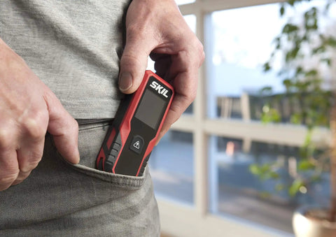Person holding 65 Feet Laser Distance Measurer With Wheel Measuring Mode For Uneven Surfaces compact handheld tool.