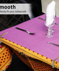 Rustproof Stainless Steel Tablecloth Clips 12 Pack For Outdoor Picnics And Parties on table with pink and patterned tablecloth.
