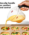 Angled 2 Cup Measuring Cup With Easy Read From Above Measurements BPA Free Tritan Renew pouring batter into muffin tin