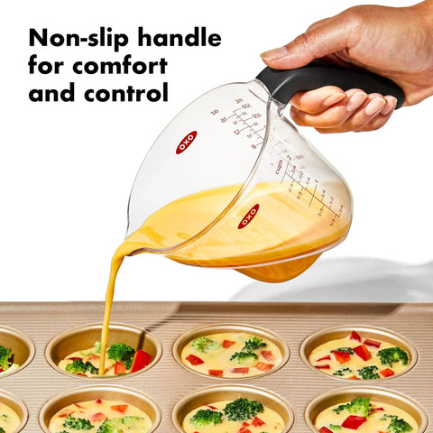 Angled 2 Cup Measuring Cup With Easy Read From Above Measurements BPA Free Tritan Renew pouring batter into muffin tin