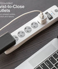 No Fuss Rock Solid Surge Protector Power Strip With Ten Foot Extension Cord Packing Six Grounded Outlets and Reliable Eight Hundred Joule Coverage for Home Office Tech and Garage Gear on wooden desk.