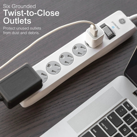 No Fuss Rock Solid Surge Protector Power Strip With Ten Foot Extension Cord Packing Six Grounded Outlets and Reliable Eight Hundred Joule Coverage for Home Office Tech and Garage Gear on wooden desk.