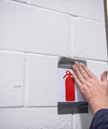 Person applying Multi-Use Silver Duct Tape 1.88 in x 60 yd x 7 mil, Contractor Grade for temporary repair on wall
