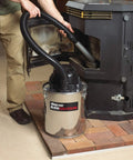 Heavy Duty Ash Vacuum Stainless Steel 5 Gallon With Bypass Motor, HEPA Filter, and Vinyl Cover in use on pellet stove