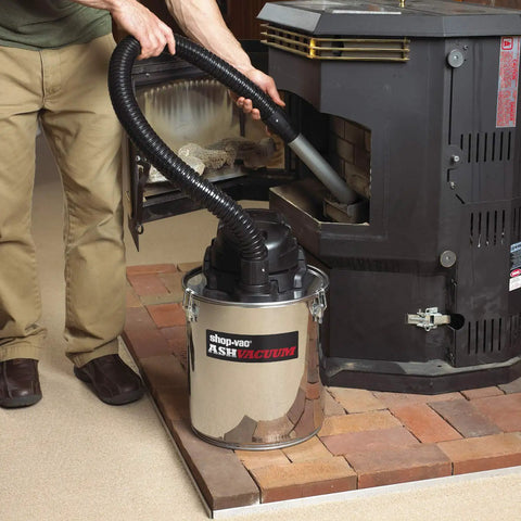 Heavy Duty Ash Vacuum Stainless Steel 5 Gallon With Bypass Motor, HEPA Filter, and Vinyl Cover in use on pellet stove