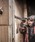 Heavy Duty 18V Cordless Impact Drill Packs Killer 110Nm Torque And Dual Speed Gears With Two Rugged 4.0Ah Batteries Plus Bright Led Work Light For Serious Weekend Warriors in use on wood.