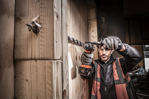 Heavy Duty 18V Cordless Impact Drill Packs Killer 110Nm Torque And Dual Speed Gears With Two Rugged 4.0Ah Batteries Plus Bright Led Work Light For Serious Weekend Warriors in use on wood.
