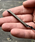 Ultra Lightweight Titanium Keychain Pry Bar With Minimalist Slim Design Everyday Carry Essential shown on a hand close-up