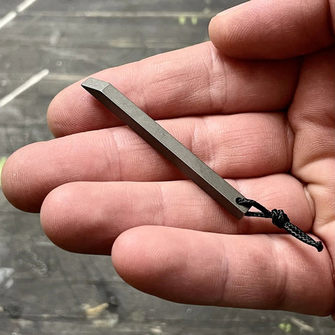 Ultra Lightweight Titanium Keychain Pry Bar With Minimalist Slim Design Everyday Carry Essential shown on a hand close-up