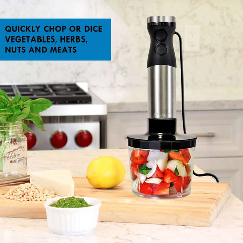 Badass Handheld Immersion Blender With Turbo Pulse Power And Four Rock Solid Stainless Blades, Includes Quick Snap Chopper Bowl And Wire Whisk To Crush Blending Jobs Without Breaking A Sweat, shown chopping veggies sitting on a kitchen countertop.
