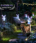 Solar Angel Garden Stake Lights 2 Pack With 7 LEDs illuminate a garden path with a warm glow, showcasing stainless steel angel figures.