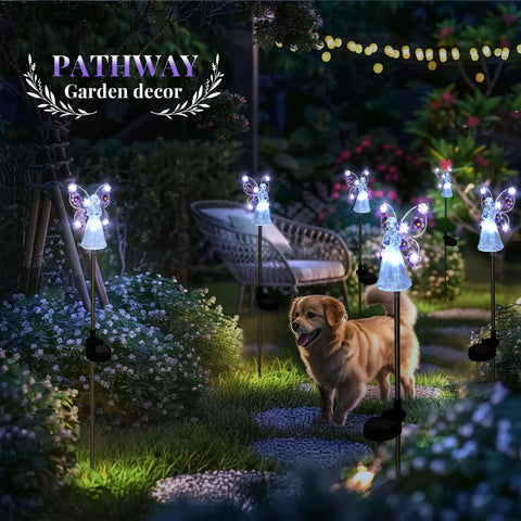 Solar Angel Garden Stake Lights 2 Pack With 7 LEDs illuminate a garden path with a warm glow, showcasing stainless steel angel figures.