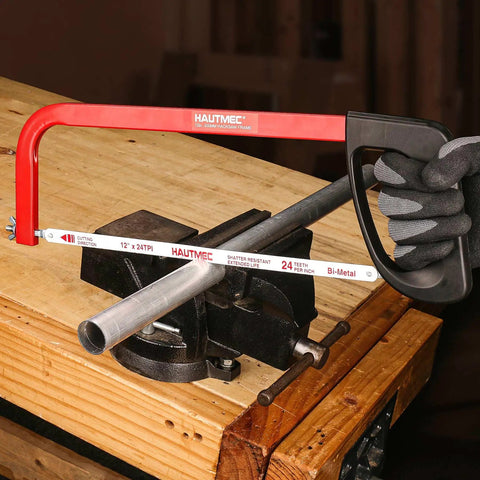 12 Inch Hacksaw With High Tension Frame And 24 TPI Bi Metal HSS Blade For Cutting Metal Steel Pipe PVC And Wood Hand Saw HT0398 Beefy For Metalworking, Carpentry, And DIY Projects; Built Tough For Consistent, Straight Cuts in use cutting metal pipe on workbench.