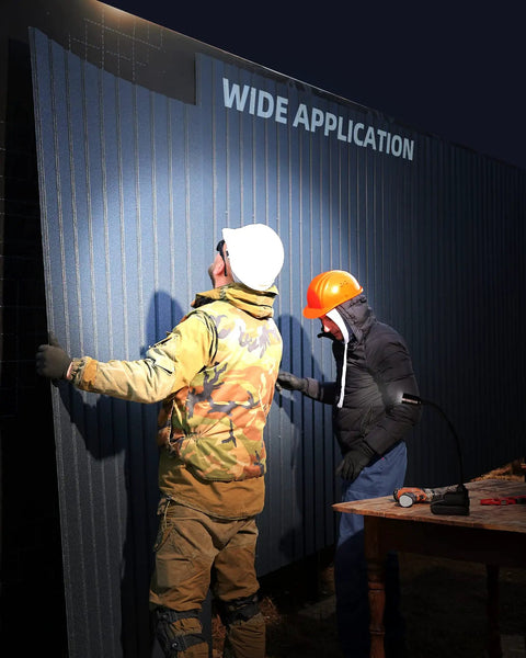 Two workers in hard hats illuminated by Boss Level Ultra Bright 2000 Lumen Magnetic Gooseneck Work Light during nighttime job site work.
