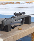 Rifle resting on blocks with Baktrak Traction Web Rifle Sling 36 Inch With 500Lb Rated Swivels And Slim Non Slip Pad Black And Gray