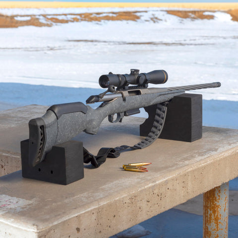 Rifle resting on blocks with Baktrak Traction Web Rifle Sling 36 Inch With 500Lb Rated Swivels And Slim Non Slip Pad Black And Gray