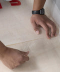 Top Shelf 100 Square Foot Laminate And Engineered Wood Flooring Underlayment Roll, hands unrolling heavy duty foam backing.