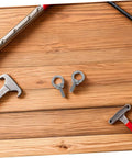 Heavy Duty Stainless Steel Eye Bolts With Nuts And Washers M6x20 For Concrete Hanging Hooks And Ring Holes Anti Loosening Nylon Nuts With Flat And Spring Washers Durable Eye Bolts For Secure Load Lifting, two stainless M6 eye bolts on wood