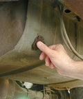 Hand applying Instant Gas Tank And Radiator Repair Epoxy Putty That Grips Wet Surfaces, Steel Reinforced to car tank