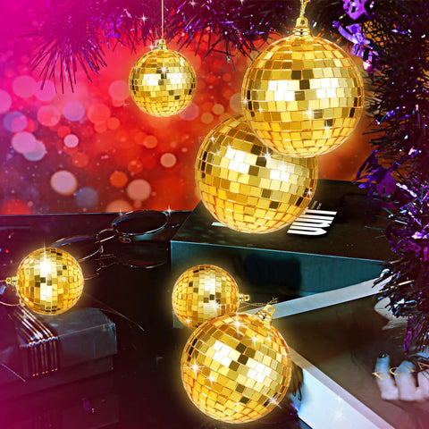 25 Pcs Disco Balls Ornament Set Mini Reflective Party Hanging Balls With Lanyard Gold 2 Inch 3.14 Inch 4 Inch displayed on table.