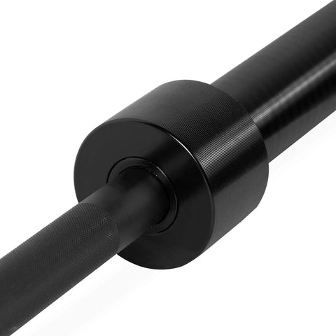 Close-up of Elite Seven Foot Olympic Weight Bar Built Different With Stainless Spin Sleeves showcasing aggressive knurling.