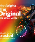 Cyclist at night with RGB LED Bike Wheel Lights For Night Rides 1 Pack Lit Kid Safe Glow For Wheels And Spokes Fun Bike Accessory.