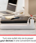 6-Outlet Surge Protector Power Strip Set With 2 Ft Extension Cords, 620 Joules, in use on desk setup with devices, white