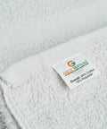 Close-up of Heavy Duty Pro Grade White Cotton Blend Hand Towels Bulk Pack 120 Pcs 16x27 Inches Rags In A Box label