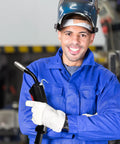 Must Have Gas Electric Welder Torch Parts With Copper Stinger, man holding sleek welding torch in blue work suit.