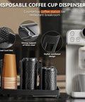 Image of a three slot upright paper cup and lid dispenser with 3 oz to 16 oz cups in black, next to a coffee machine.