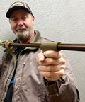 Person holding Slock Master Blow Gun 5 Foot Long 625 Big Bore Caliber with Pistol Grip, Dart Quiver, and Anodized Bronze Finish.