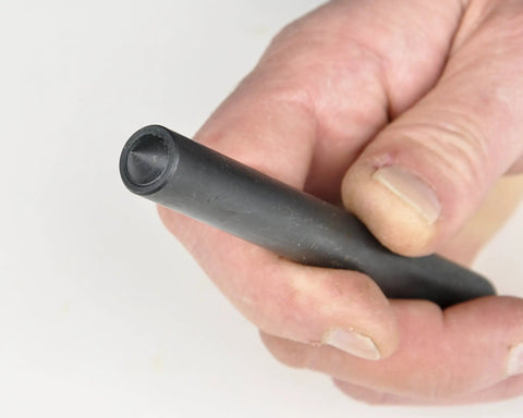 Close-up of a hand holding a tool from Steel Transfer Punch Set With Index Stand 28 Piece Pack For Machinists And Tool Cribs Sizes Range.