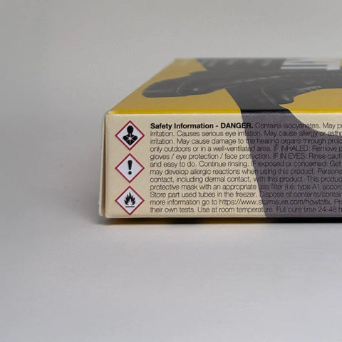 Side view of Boot And Shoe Repair Kit With Flexible Waterproof Adhesive, focusing on safety information and hazard symbols on packaging.