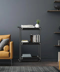 Slim 3 Tier Rolling Storage Cart for Narrow Spaces Black Metal Frame with Easy Glide Casters in a living room setting
