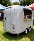 Kickstart Your Food Truck Trailer And Hot Dog Cart Venture With Commercial Mobile Kitchen Rig For Coffee Shop And Ice Cream Stand Business Hustle Dope Full Setup, silver portable food trailer with serving window.