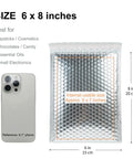 Fifty Pack 6x8 Inch Thermal Insulated Bubble Mailers for Cold Shipping with metallic silver foil padded envelopes shown with phone for size comparison.