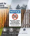 Heavy Duty Aluminum Bilingual Privacy Warning Sign Rock Solid For Outdoors Straight Up No Recording Or Taping Allowed Top Shelf Rust Resistant Security Notice 10X14 Inches on a fence in harsh weather conditions.