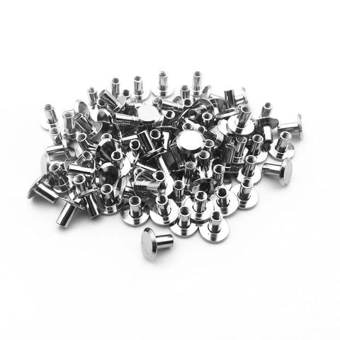 50 Pack Nickel Plated Chicago Screws Featuring Durable Carbon Steel Build And Easy Grip Cross Head For Securing Leather Goods Planning Sheets And Custom Book Bindings Top Shelf Legit Craft Gear in a pile.