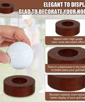 Hand holding a wooden golf ball display stand for desk with 2 inch ball holder, showcasing walnut finish and texture details.