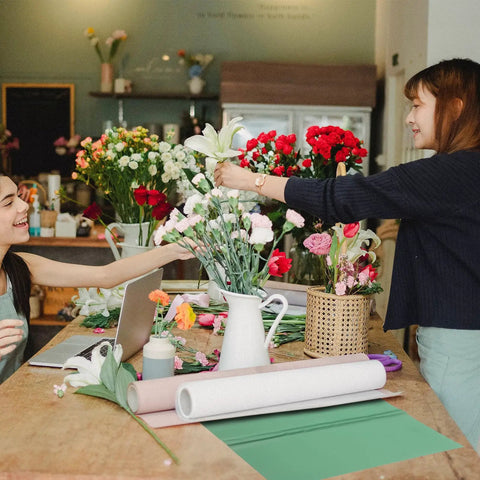 Florists preparing bouquets with Pearlescent Floral Wrapping Paper Sheets Set 20 Pack Boss Level Breathable And Cuttable Design.