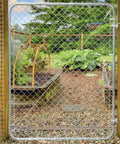 Adjustable Gate Kit For Chain Link Fence With Round Frame That Fits 24-72 Inch Openings And Up To 12 Feet installed in garden