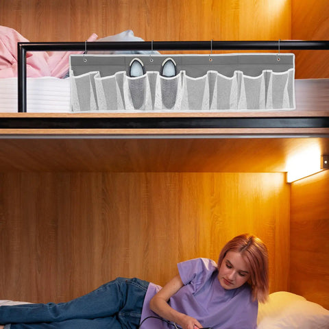 Compact Mesh Shoe Storage Hangs Beside Bed With 4 Hooks For RV Camper And Home To Stash Sneakers And Boots While Keeping Floors Tidy, gray fabric with shoes organized in mesh pockets.