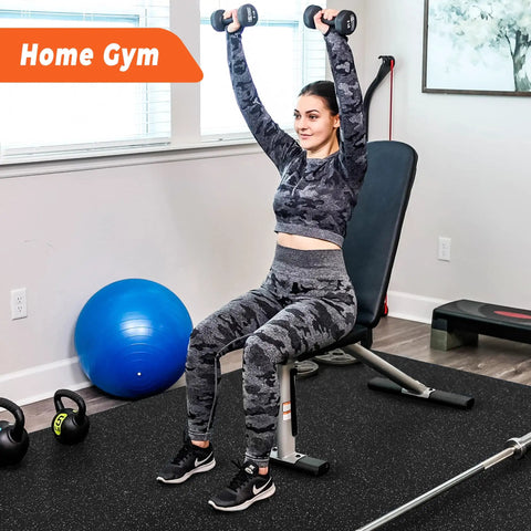 Interlocking Gym Floor Mats With Rubber Top 0.4 Inch Thick 24 Pieces Covering 96 Sq Ft Dual Layer High Density EVA Foam Base With Rugged EPDM Rubber Surface Heavy Duty Home Gym Flooring For Exercise Gear Black And Grey visible underneath exercise equipment in home setting.