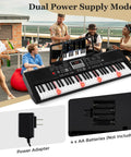 61 Key Portable Keyboard Piano With Light Up Keys showing power supply options, adapter, and battery slots