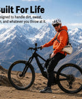 Cyclist wearing Mountain Bike Hydration Pack With 3L Bladder And 10L Storage For Trail Rides, mountain backdrop