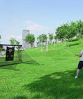 Man practicing with 10x7Ft Golf Practice Net With Target Mat For Backyard Driving And Chipping Training in a park setting