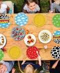 Legendary 7 Inch Cartoon Story Paper Plates 60 Pack Boy Birthday Party Supplies Sky Blue Cow Print Cloud Dessert Dishes on table.