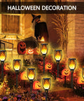 Outdoor Solar Torch Lights Set With 96 LED Beads illuminating a yard with Halloween decorations, showing dancing flame effect.
