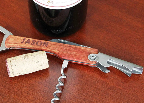 Custom Engraved Corkscrew Multi Tool With Bottle Opener And Free Text Perfect Personalized Gift For Men Groomsmen Birthdays Weddings And Party Hosts Man Cave Ready Durable Stainless Steel Travel Friendly Gift on wooden table with cork and wine bottle