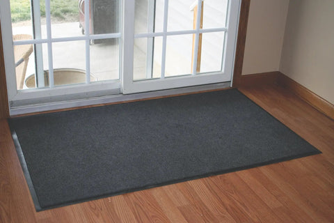 Vinyl-Backed Indoor Entrance Mat That Kicks Dirt Out Doorway Guard Doormat 3 By 4 Feet Charcoal in front of glass door
